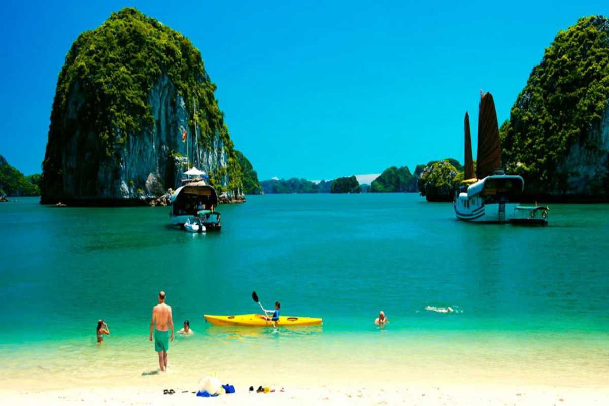 Boats sailing near towering limestone islands in Halong Bay close to Soi Sim Island