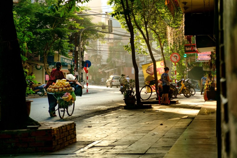 Local Street Market in Hanoi French Quarter A vibrant morning street market scene in the Hanoi French Quarter with vendors and locals bustling along the streets.