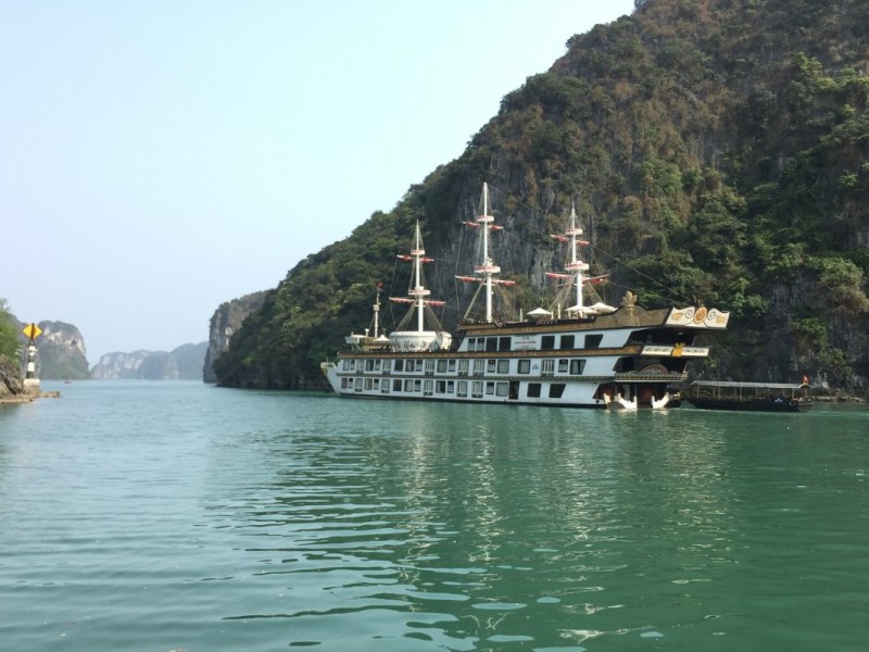 Luxury cruise anchored near Cong Do Island A luxury cruise ship anchored near the limestone cliffs of Cong Do Island in Bai Tu Long Bay.