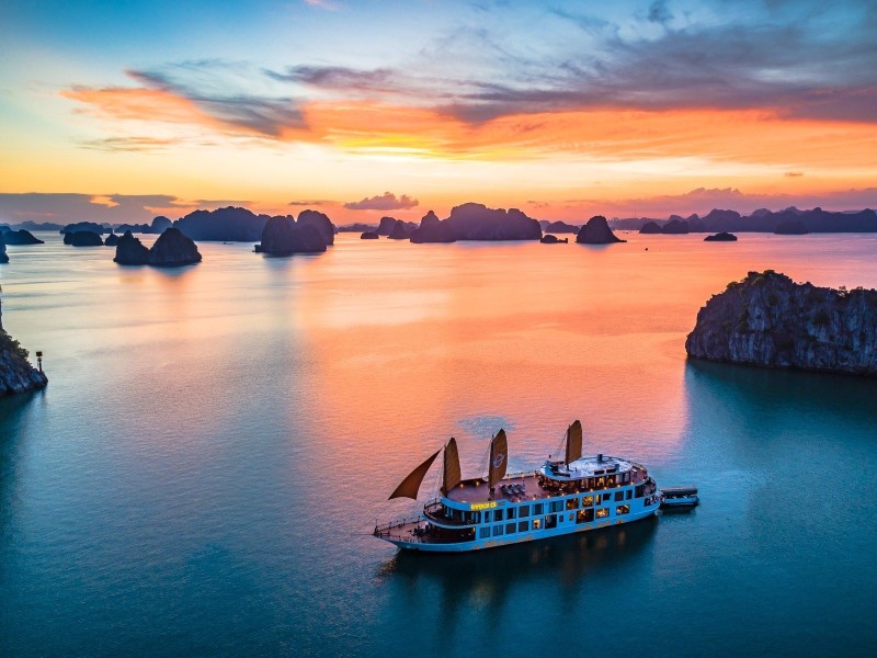 Luxury Cruise to Xep Islet at Sunset in Halong Bay A luxury cruise sailing through Xep Islet in Halong Bay at sunset