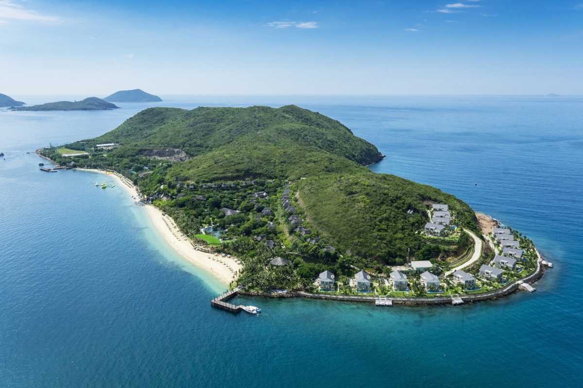 Aerial view of luxury beach resort on island near Hon Mot Island with villas and greenery