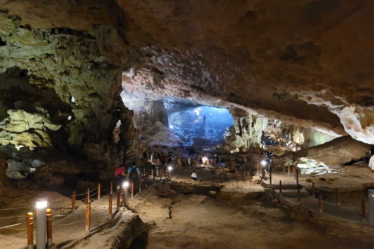 Interior of Me Cung Cave Halong Bay featuring natural rock formations lit with soft artificial lighting.