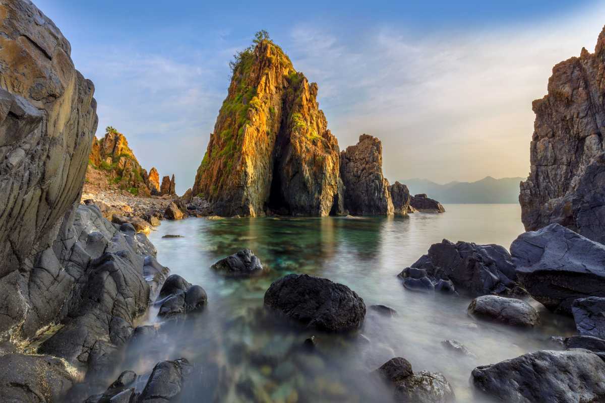 Rock formations in Nha Phu Bay scenic coastal waters Unique rock formations rising from the calm waters of Nha Phu Bay, showcasing the natural beauty of this Nha Trang coastal destination.