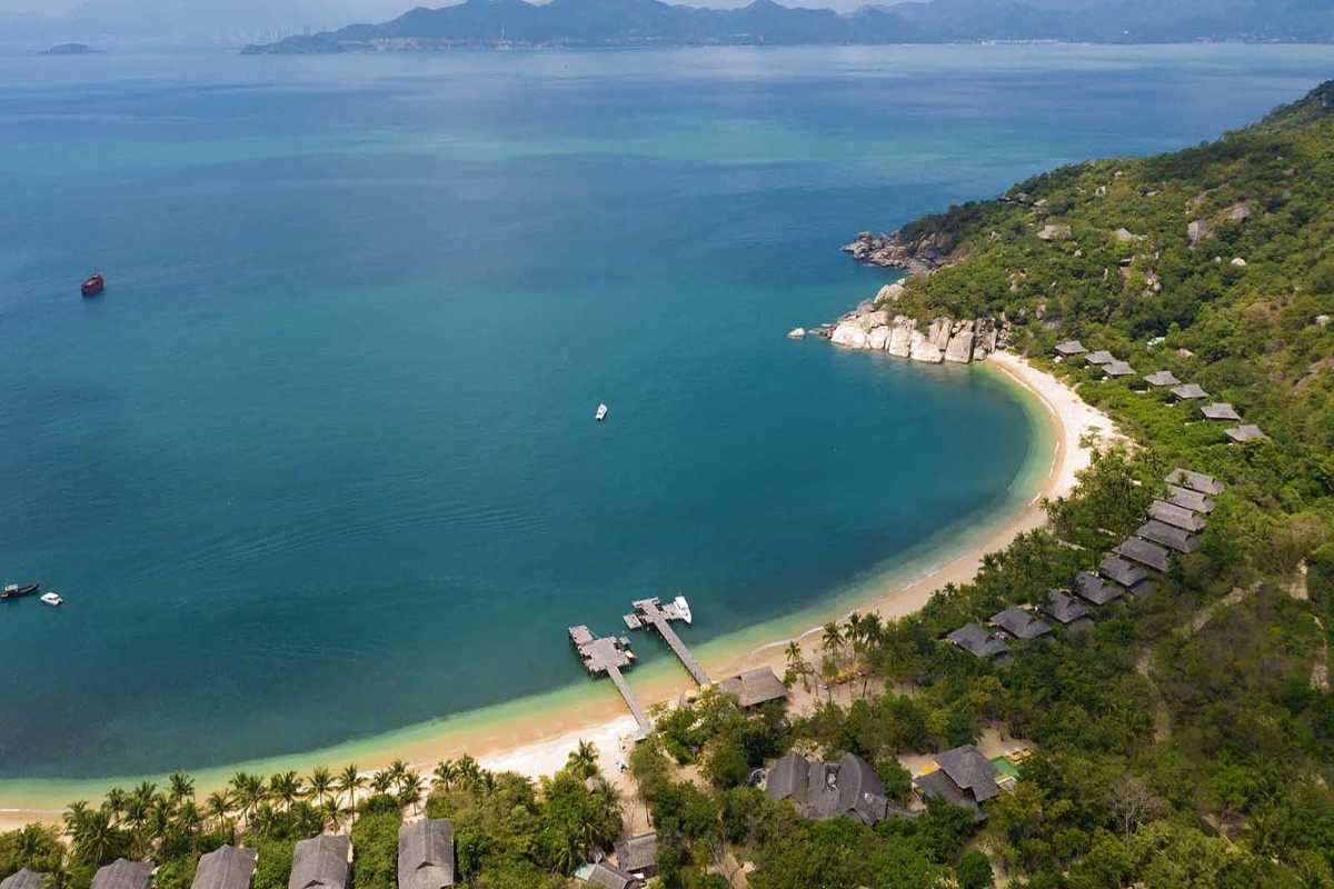 Aerial view of Ninh Van Bay beach Aerial photo of crescent-shaped beach with villas and lush hills at Ninh Van Bay.