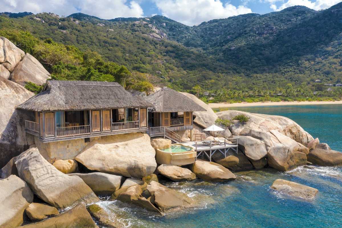 Rockside villa with ocean pool Traditional thatched villa on large rocks above the sea at Ninh Van Bay.