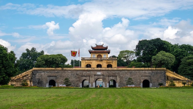Panoramic View of the Imperial Citadel of Thang Long in Hanoi A panoramic view of the Imperial Citadel of Thang Long in Hanoi, with lush greenery and the ancient gate standing tall against the blue sky.