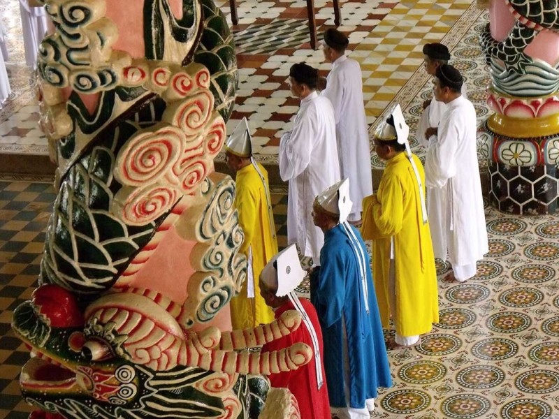 Prayer Ceremony at Cao Dai Temple Worshippers attending a colorful prayer ceremony at Cao Dai Temple.
