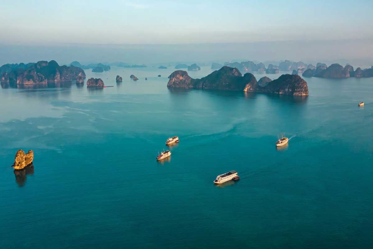 Visitors enjoying sunbathing and beach activities on the sandy shores of Quan Lan Island