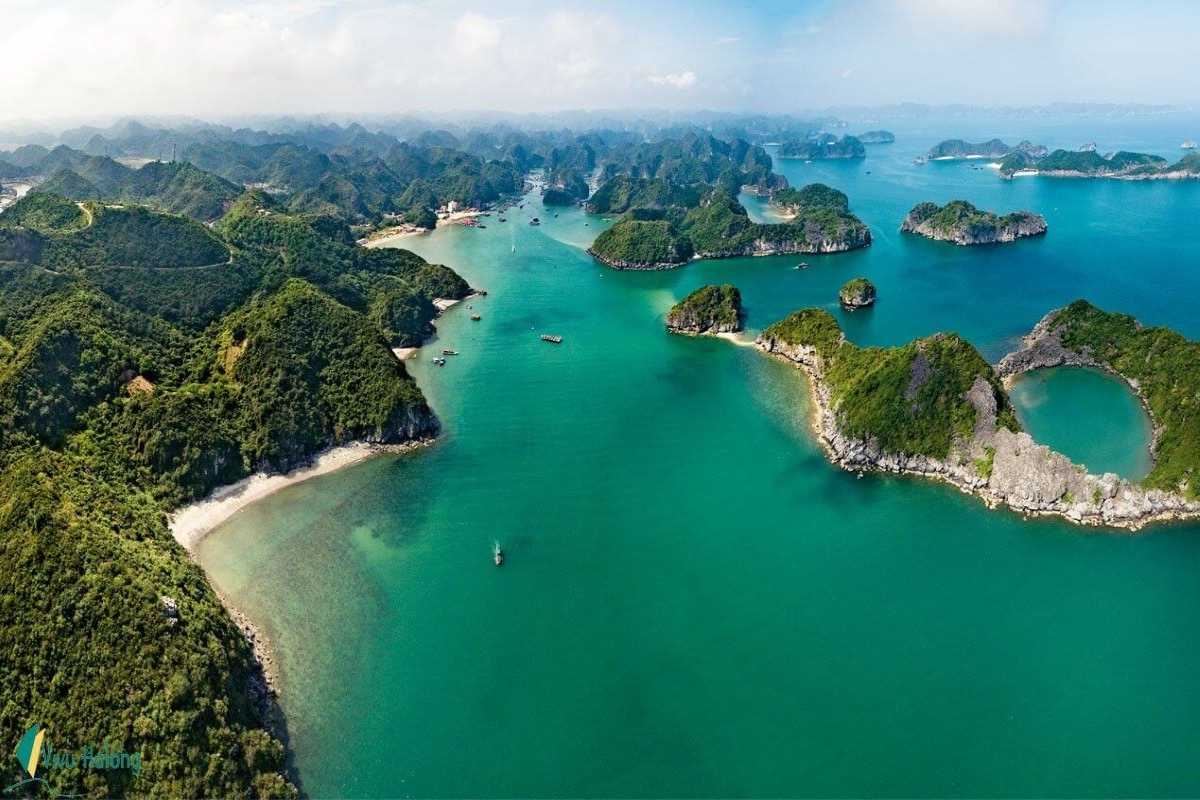 Harbour with docked boats and nearby beach resort on Quan Lan Island