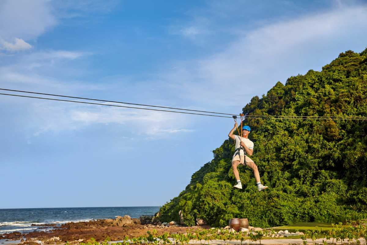 Quiet sandy beach with large rock formations on Quan Lan Island