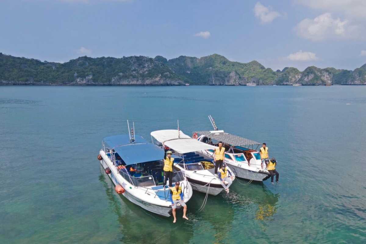 White sandy beach and clear blue sea waters at Quan Lan Island under a sunny sky