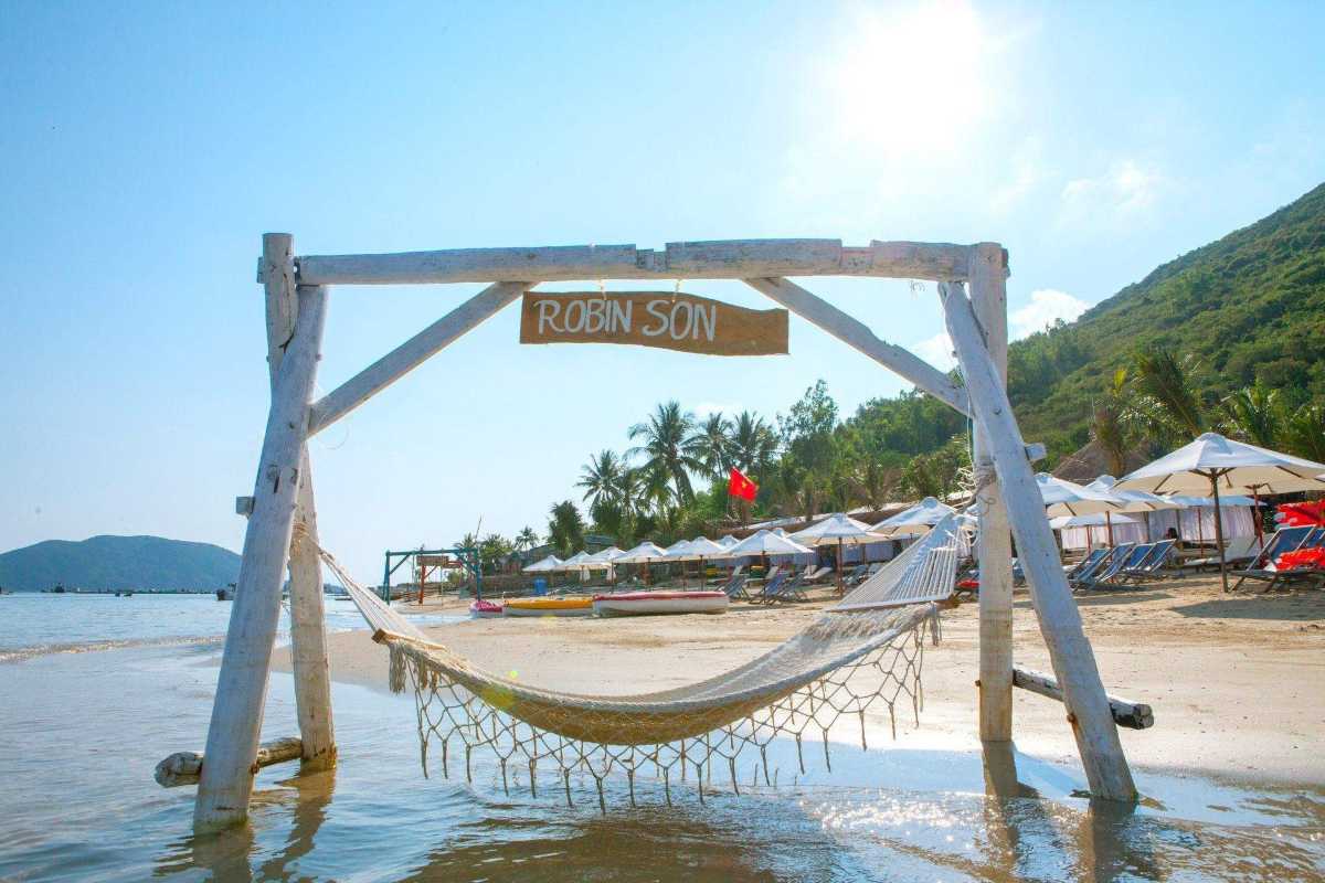 Relaxing Hammock on Robinson Beach Nha Trang A hammock hanging on the sandy shore at Robinson Beach Nha Trang under the shade of palm trees
