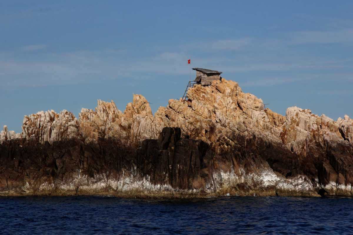 Rock Formation at Ancestor Temple of Salanganes Hon Noi Island Rock formation with a small flag near Ancestor Temple of Salanganes on Hon Noi Island, Nha Trang