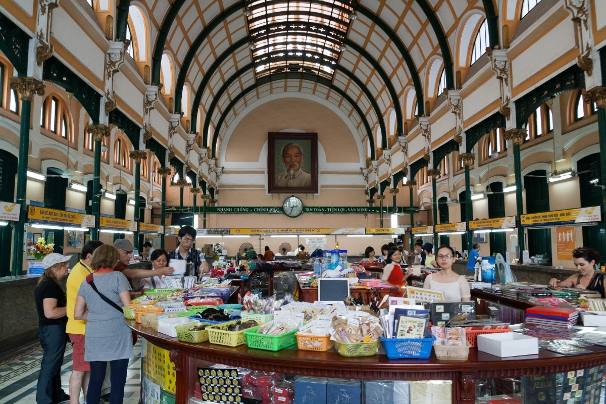 Saigon Central Post Office interior view with tourists and historical architecture