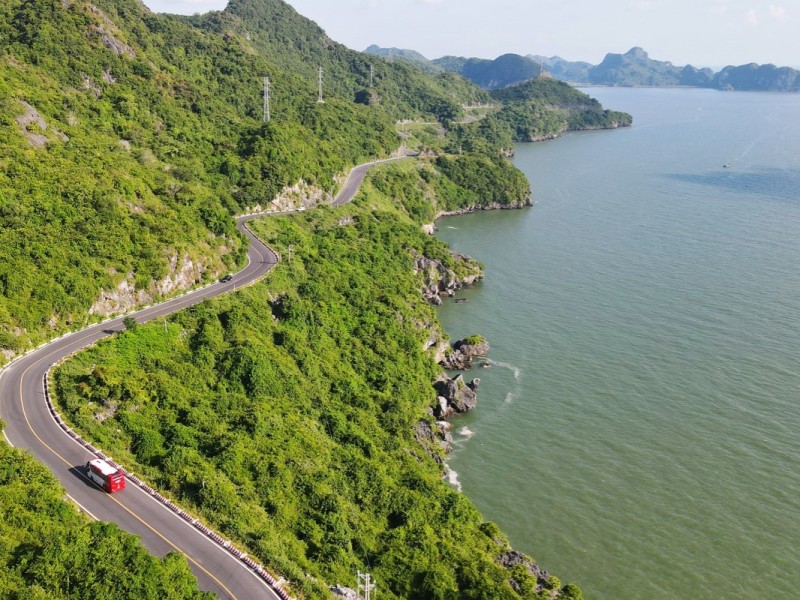 Scenic Coastal Road on Cat Ba Island A scenic coastal road winding through lush greenery on Cat Ba Island