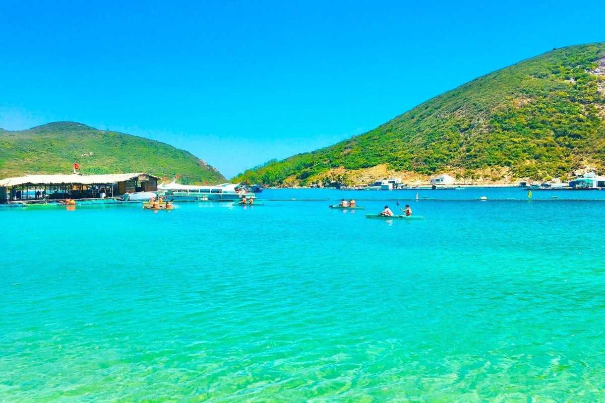 Scenic Views of Robinson Beach Nha Trang Panoramic views of Robinson Beach Nha Trang with hills, blue sky, and calm sea waters