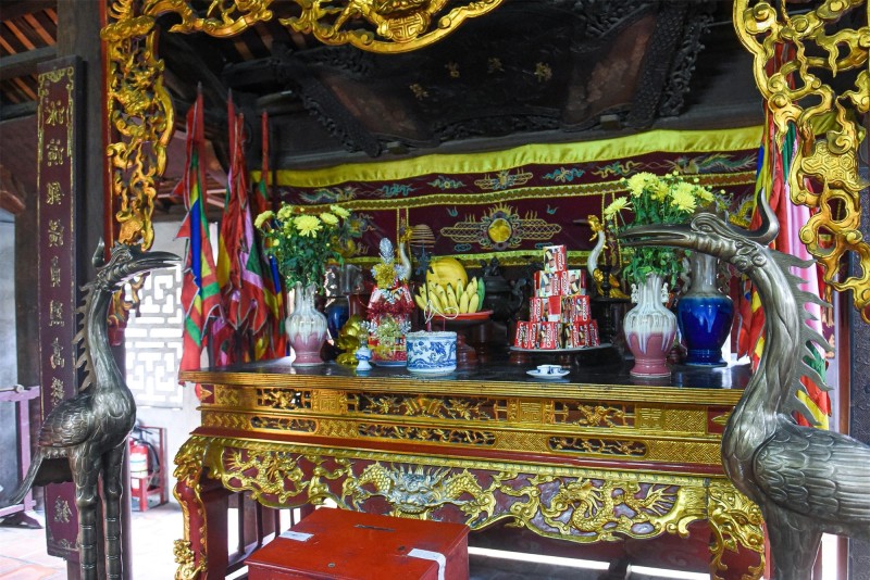 Shrine at Co Loa Ancient Citadel Shrine inside Co Loa Ancient Citadel, showcasing ornate decorations and offerings in a historical setting in Hanoi, Vietnam