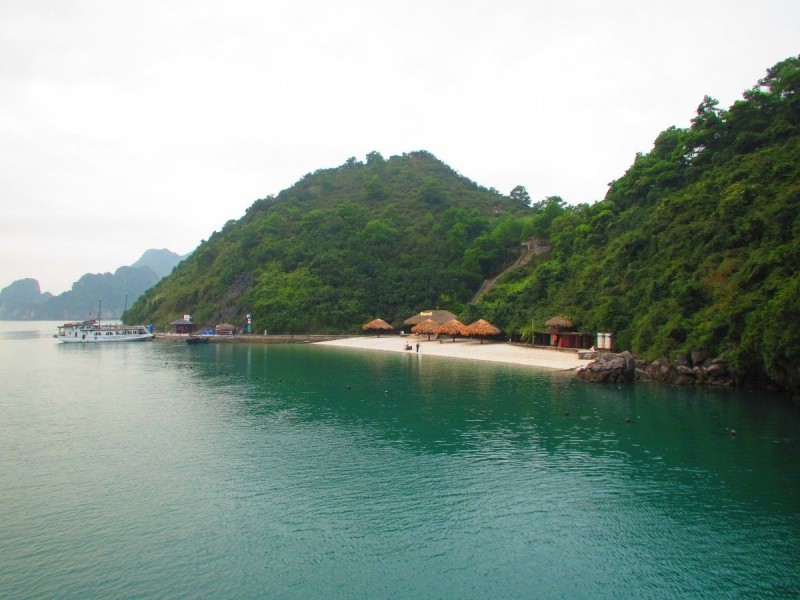 Soi Sim Island beach from a distant view A distant view of the tranquil beach at Soi Sim Island, Ha Long Bay with boats in the background.
