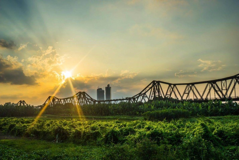 Sunset Over Long Bien Bridge, Hanoi A beautiful sunset view with sun rays shining over Long Bien Bridge in Hanoi, Vietnam.