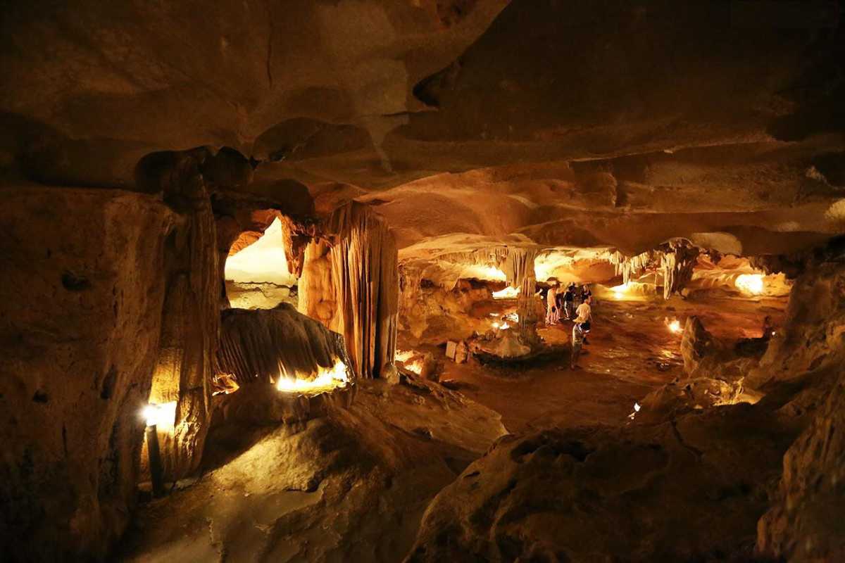 Spacious interior of Thien Canh Son Cave with visitors exploring the vast natural chambers