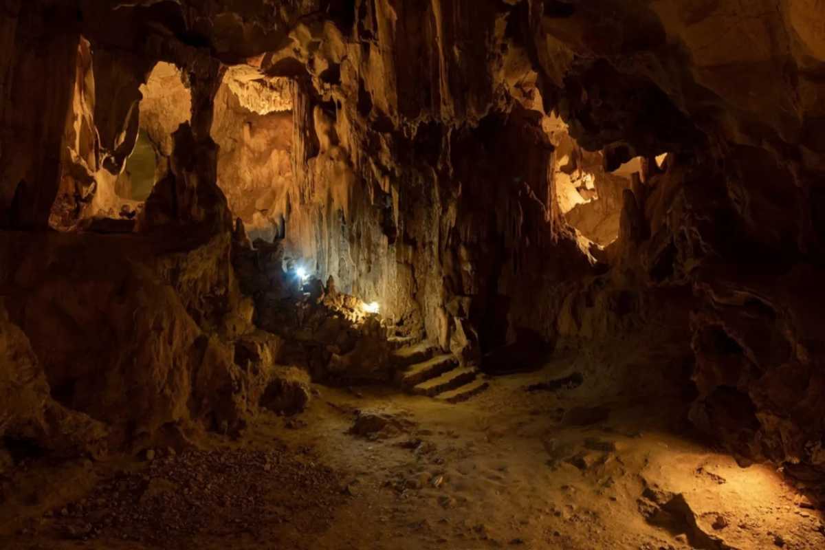 Dramatic lighting highlights rock formations and textures inside Thien Cung Cave Halong Bay