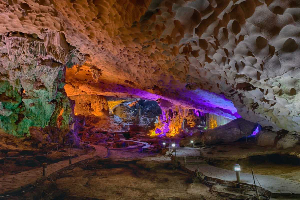 Thien Cung Cave Halong Bay features dramatic lighting accentuating unique rock formations and cavern textures