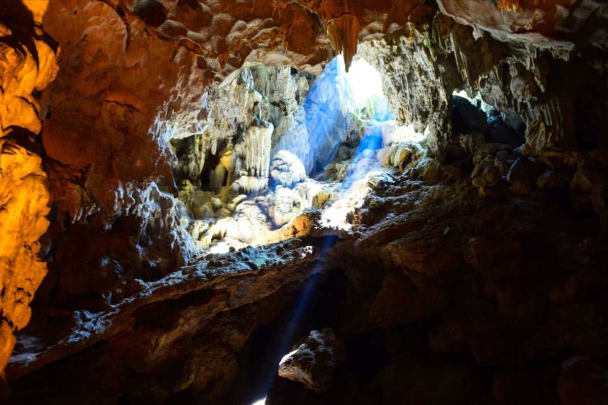 Thien Cung Cave Halong Bay showcasing stunning natural limestone formations illuminated by sunlight rays