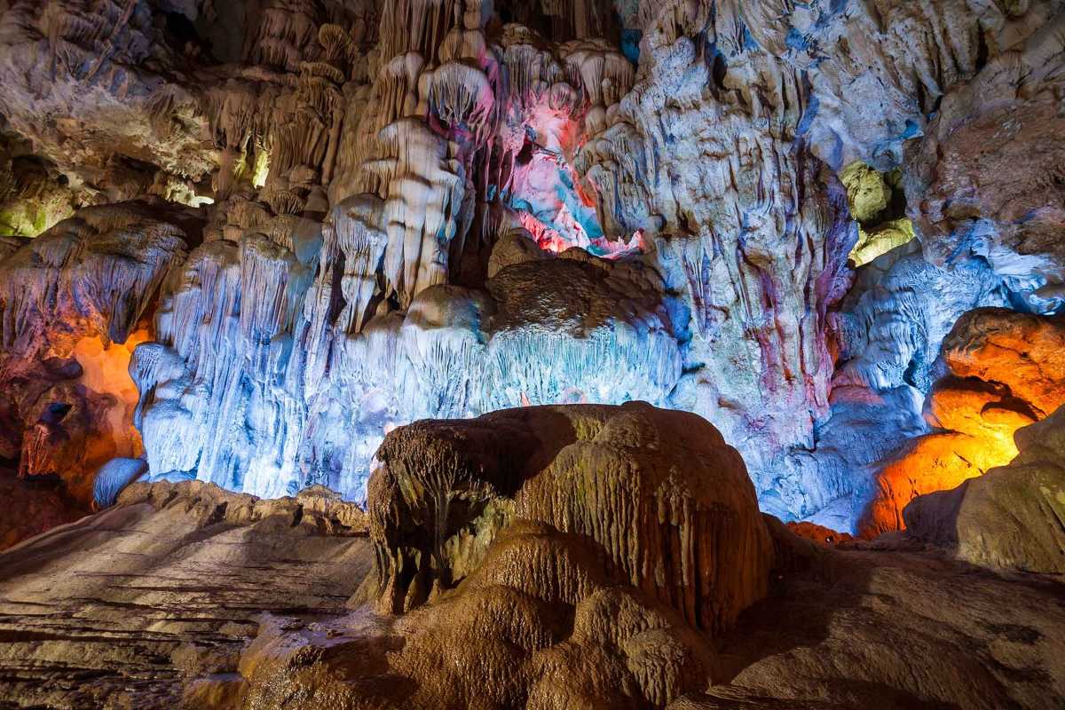 Thien Cung Cave Halong Bay displays vibrant stalactite formations illuminated by colorful lighting effects