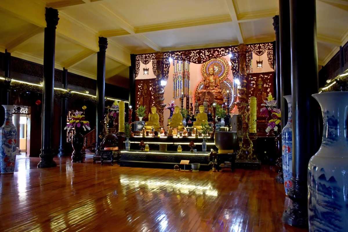 Inside view of the meditation hall at Tong Lam Lo Son Pagoda with cushions and altar