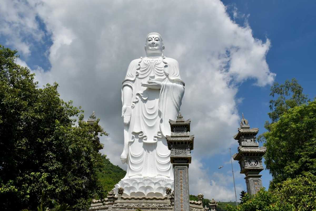 Scenic sunset casting warm light on the rooftops of Tong Lam Lo Son Pagoda surrounded by nature