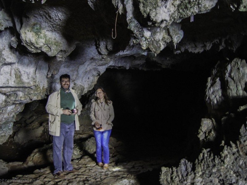 Tourists Exploring Fairy Lake Cave's Interior Tourists exploring the interior of Ho Dong Tien (Fairy Lake) Cave, highlighting the natural beauty of the cave's formations.