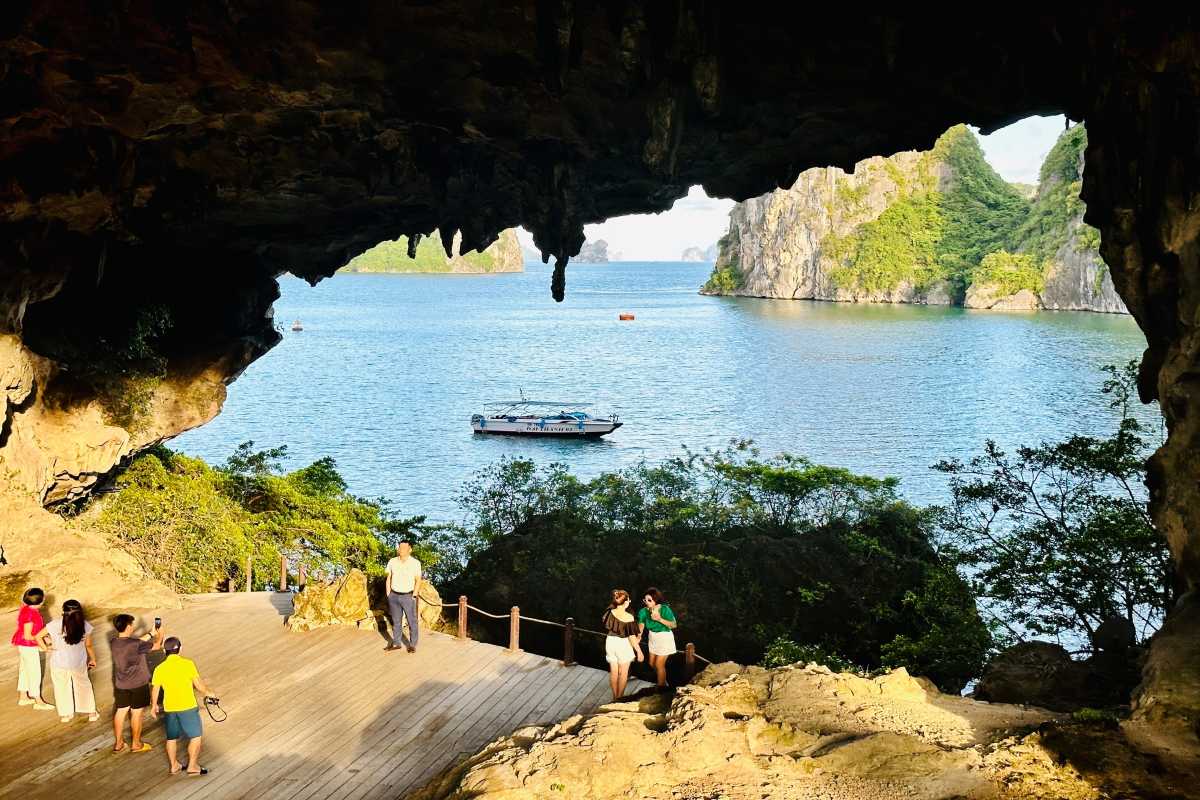 Visitors capturing photos of the stunning landscape from inside Drum Cave Halong Bay during their trip.