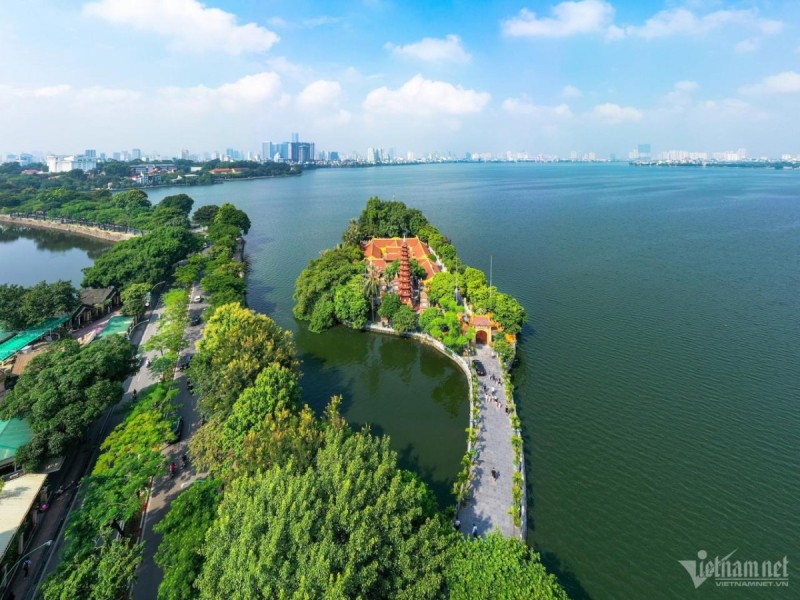 Tran Quoc Pagoda by West Lake Hanoi Tran Quoc Pagoda, an ancient Buddhist temple on an islet in West Lake Hanoi, surrounded by lush greenery and calm waters.