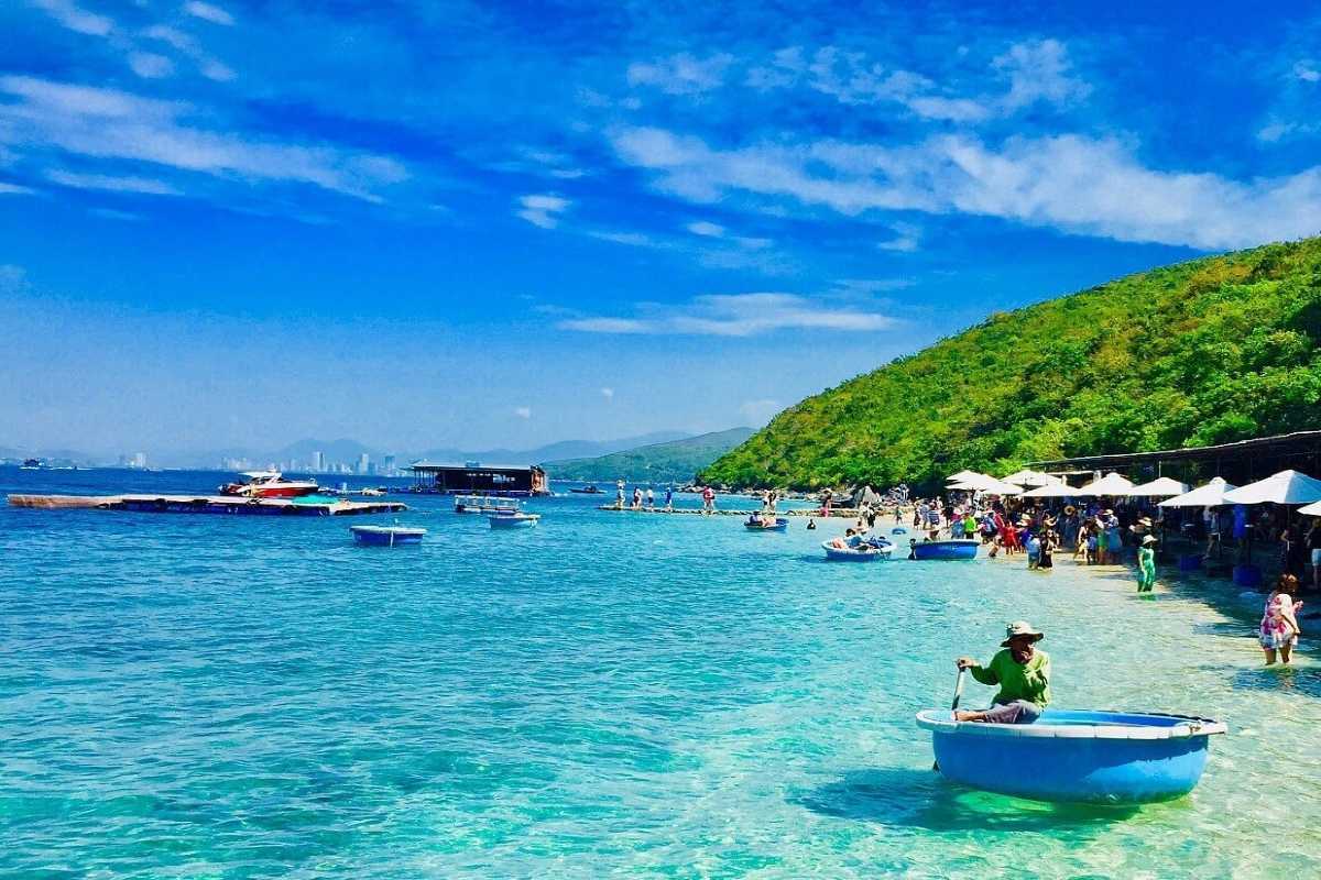 Tranh Beach Nha Trang Coastal Activity People boating and enjoying water activities along the coast of Tranh Beach Nha Trang