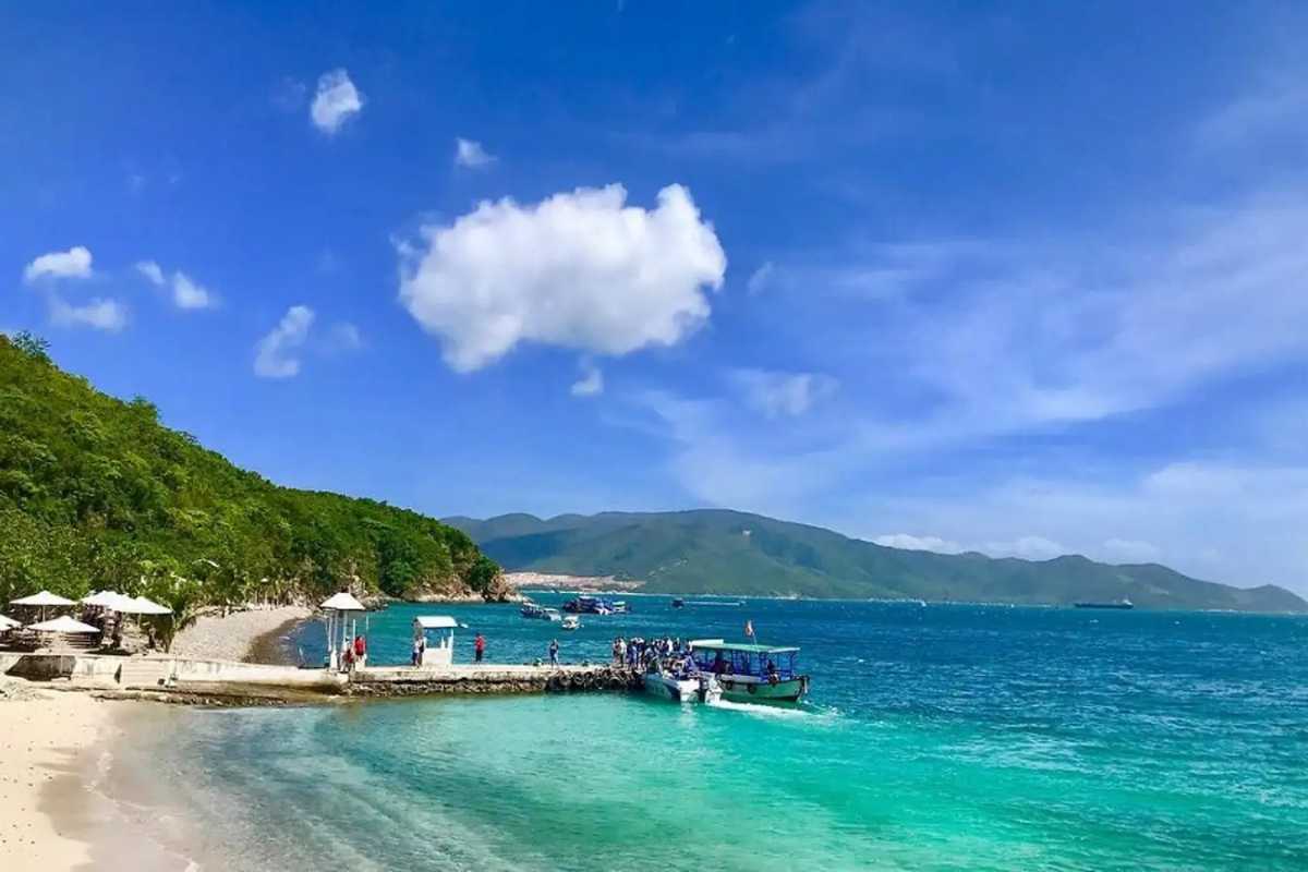 Tranh Beach Nha Trang Parasailing Adventure Parasailing activity over clear blue water at Tranh Beach Nha Trang with boats nearby