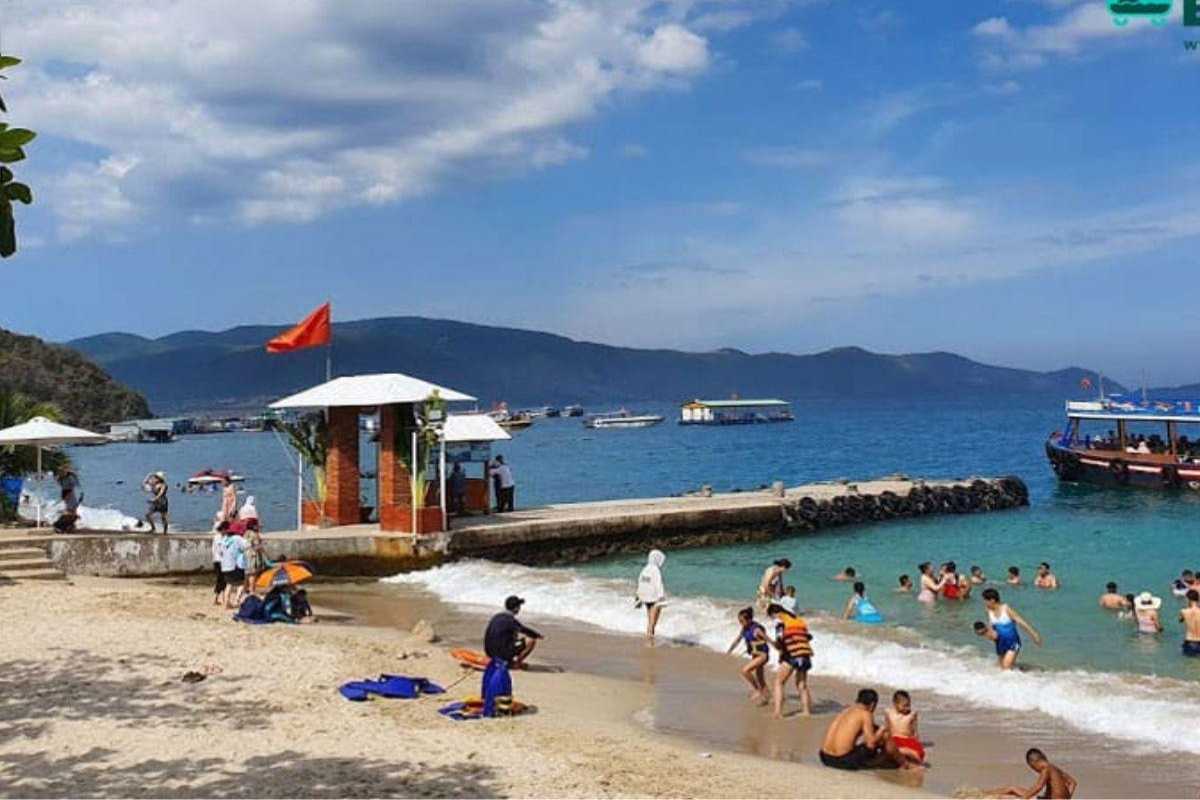 Tranh Beach Nha Trang Pier Activity Visitors boarding boats at the pier on the sandy shore of Tranh Beach Nha Trang