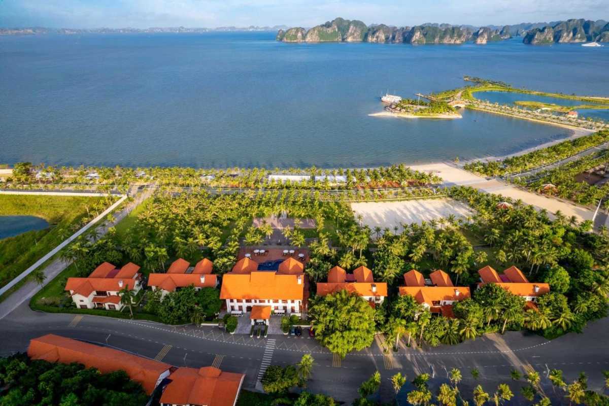 Scenic golf course surrounded by palm trees with panoramic views of Ha Long Bay at Tuan Chau Harbor Halong.