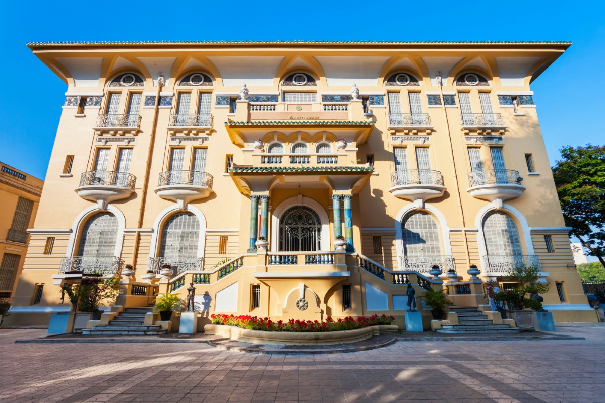 Vietnam National Fine Arts Museum Exterior Architecture Exterior view of the Vietnam National Fine Arts Museum’s yellow colonial-style building with grand staircases and balconies.