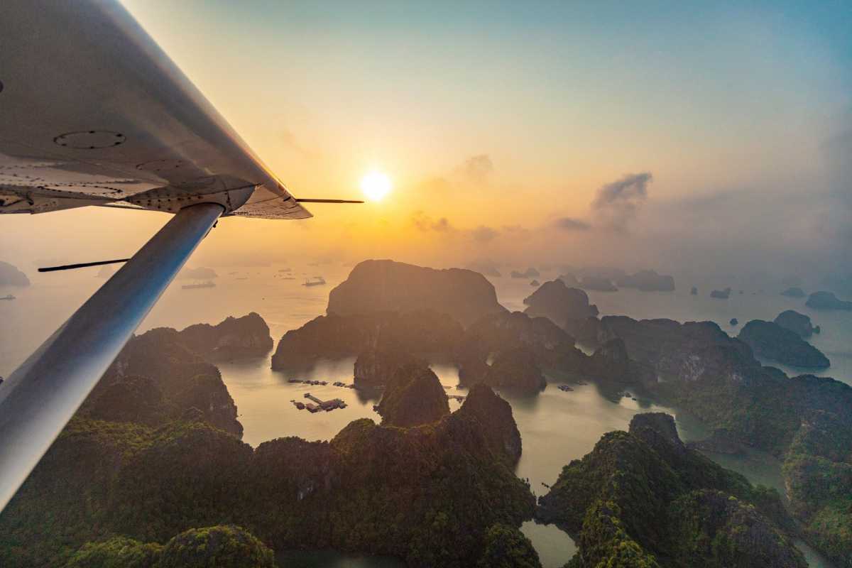 Aerial view of Virgin Cave Halong Bay showcasing limestone karsts and tranquil waters at sunrise, highlighting natural beauty