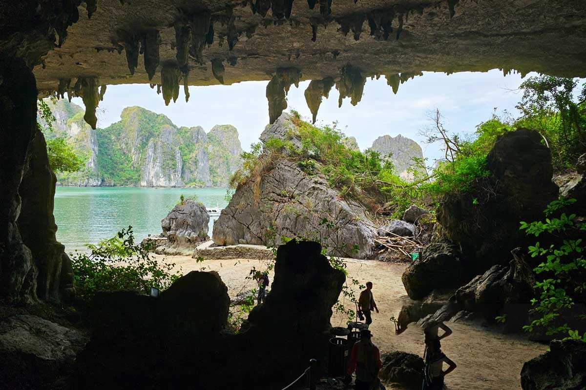 Visitors admiring the detailed stalactites and cave formations inside Virgin Cave Halong Bay
