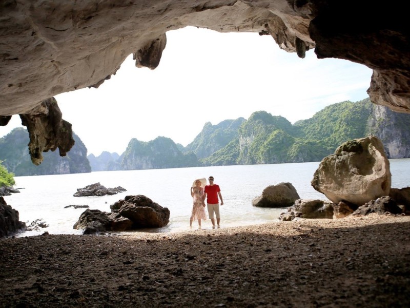 Visitors exploring the interior of Bo Nau Cave Tourists exploring the interior of Bo Nau Cave, surrounded by unique rock formations and stalactites.