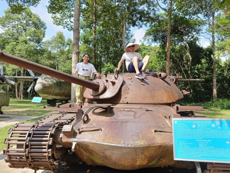 Visitors on Displayed War Tank at Cu Chi Tunnels Tourists sitting on a historic war tank at Cu Chi Tunnels