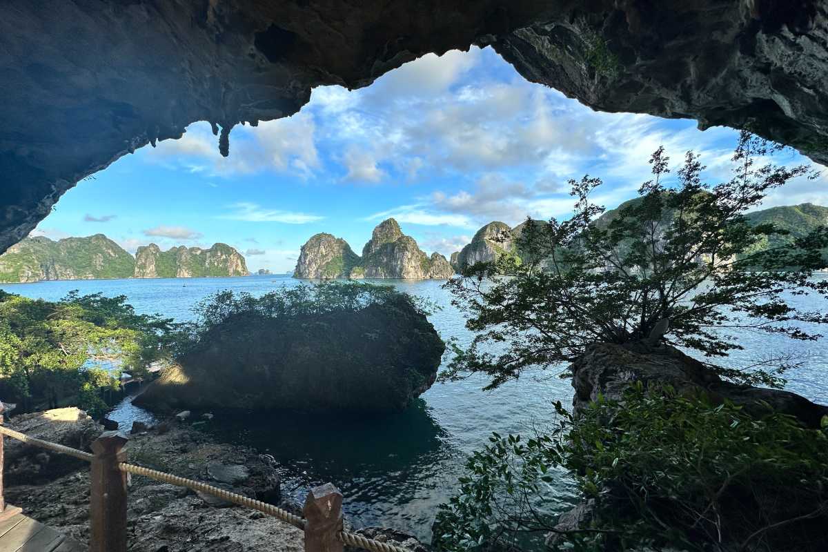 Group of visitors enjoying their visit and posing for photos at the entrance of Drum Cave Halong Bay.