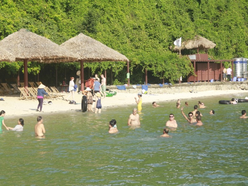 Visitors swimming at Soi Sim Island beach Tourists enjoying swimming at the pristine beach of Soi Sim Island, Ha Long Bay.