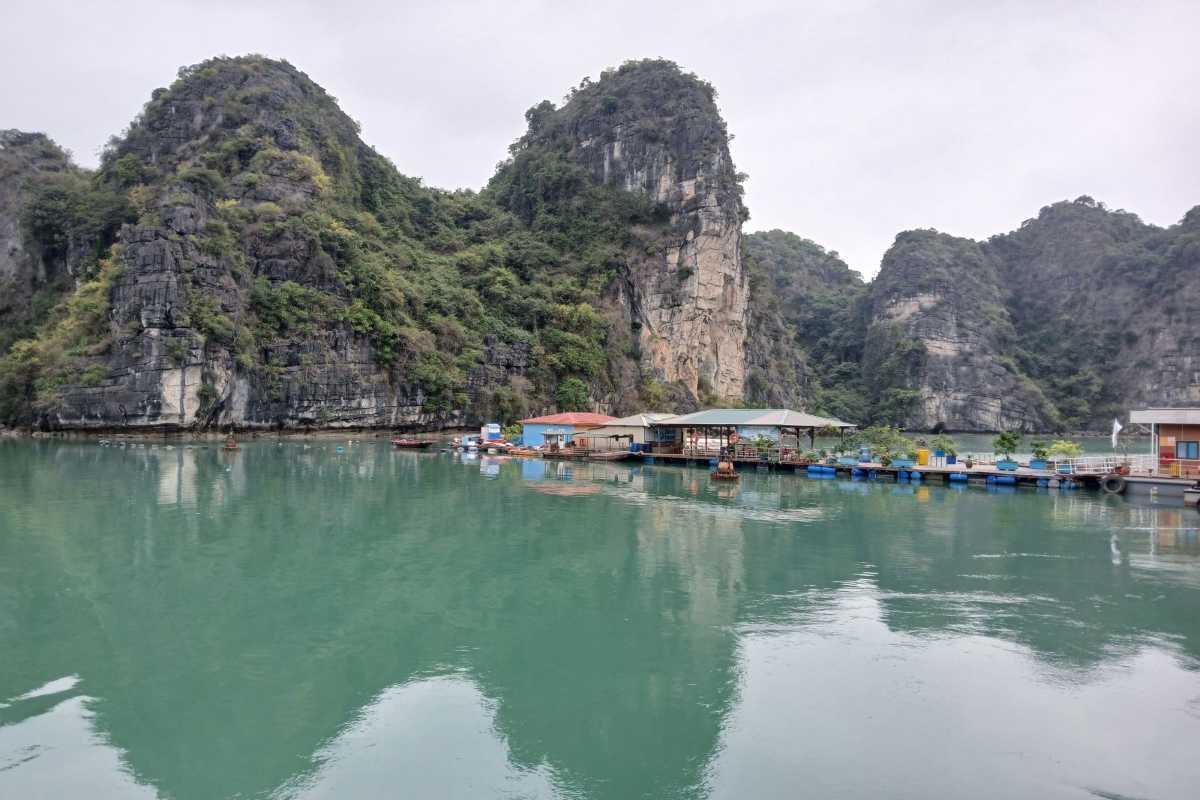 Serene waters and limestone karst formations at Vung Vieng Fishing Village in Halong Bay, Vietnam