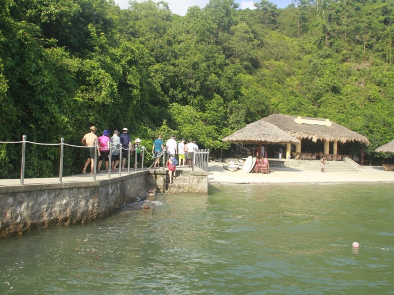 Walkway to Soi Sim Island with lush greenery Tourists walking along the scenic path to Soi Sim Island surrounded by greenery.