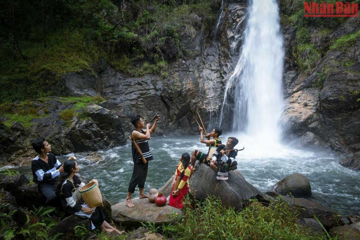 Waterfall ritual and music gathering Ethnic villagers play music and perform rituals by a powerful waterfall deep in Cai River territory.