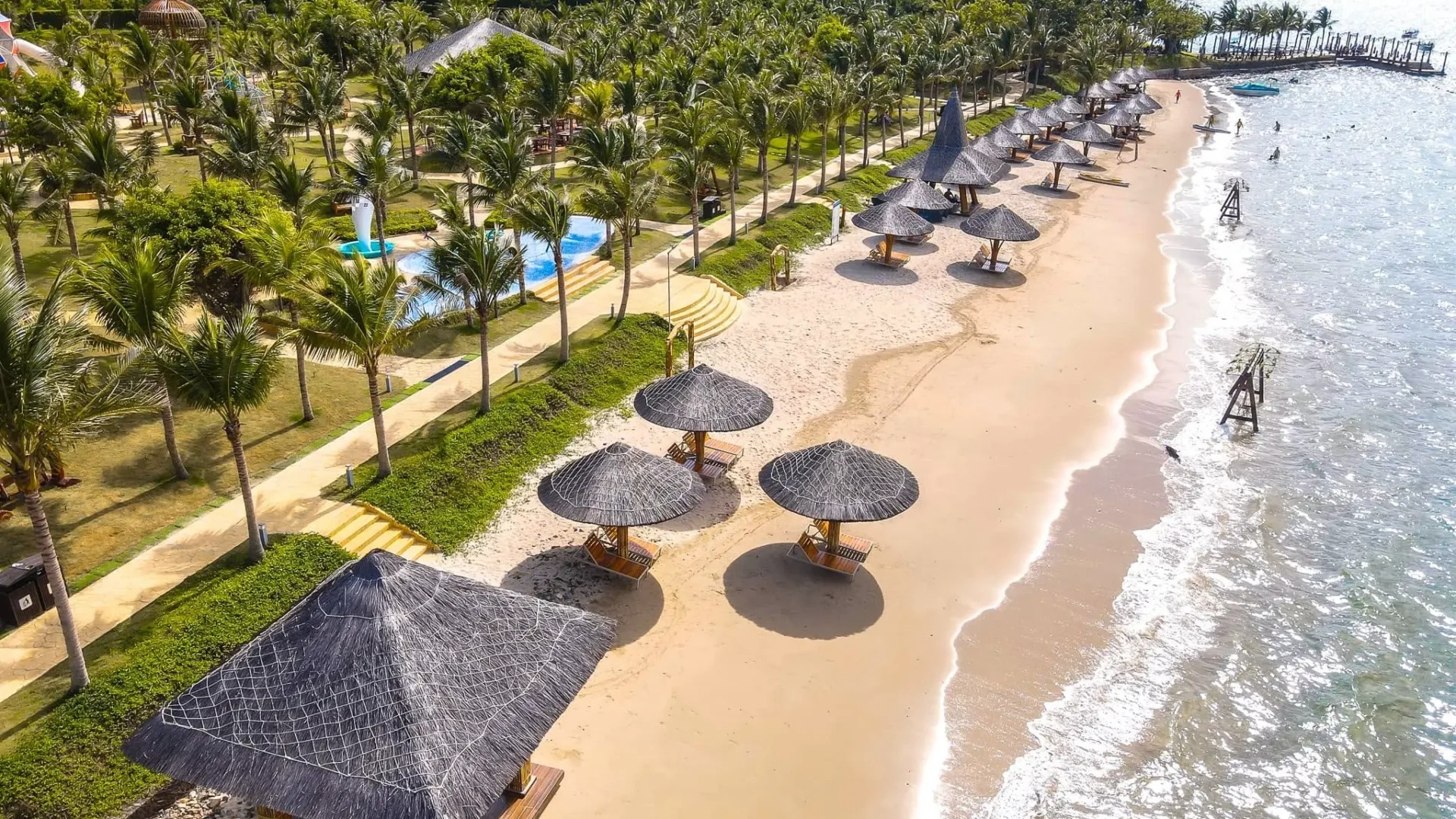 Small wooden shelters along sandy beach at Hon Noi Wooden shelters for shade along sandy beach at Hon Noi Islands, Nha Trang