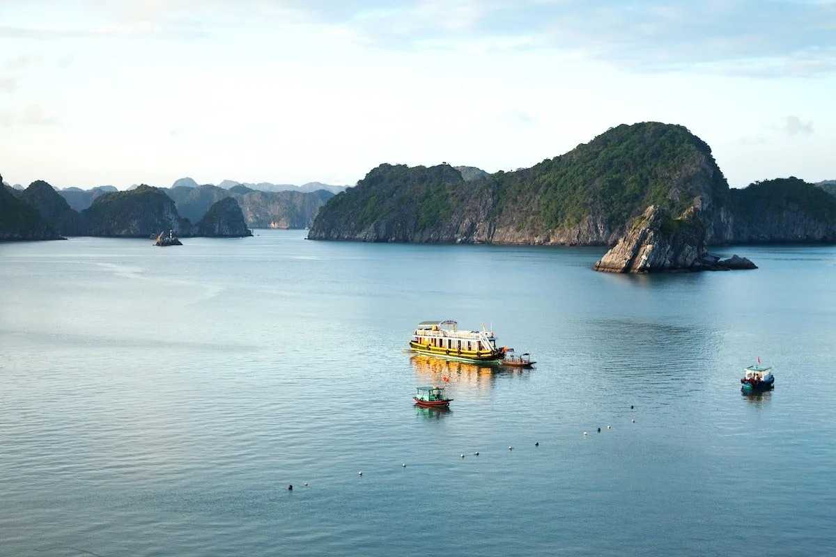Calm emerald waters around Xep Islet Halong Bay with boats and limestone islands