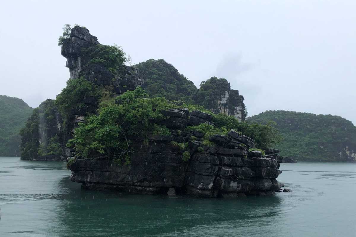 Limestone cliffs shrouded in mist at Xep Islet Halong Bay creating a mystical atmosphere